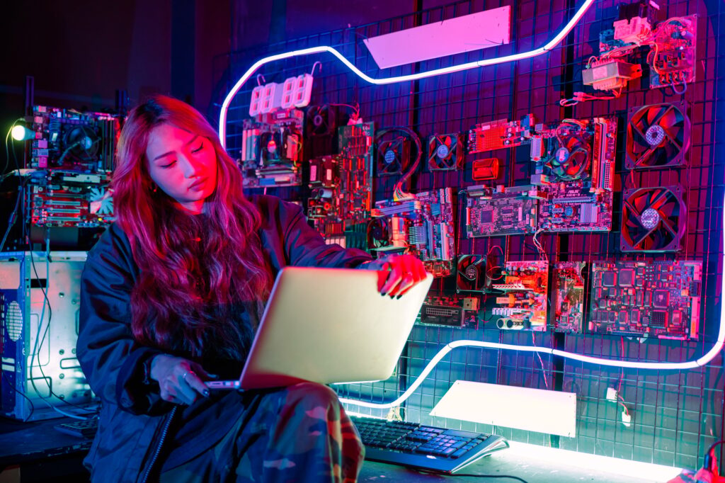 Asian woman is sitting at a desk with a laptop service in server room, Thinking and solve problems