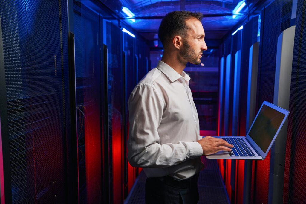 Bearded concentrated professional it specialist working with telecommunication equipments in