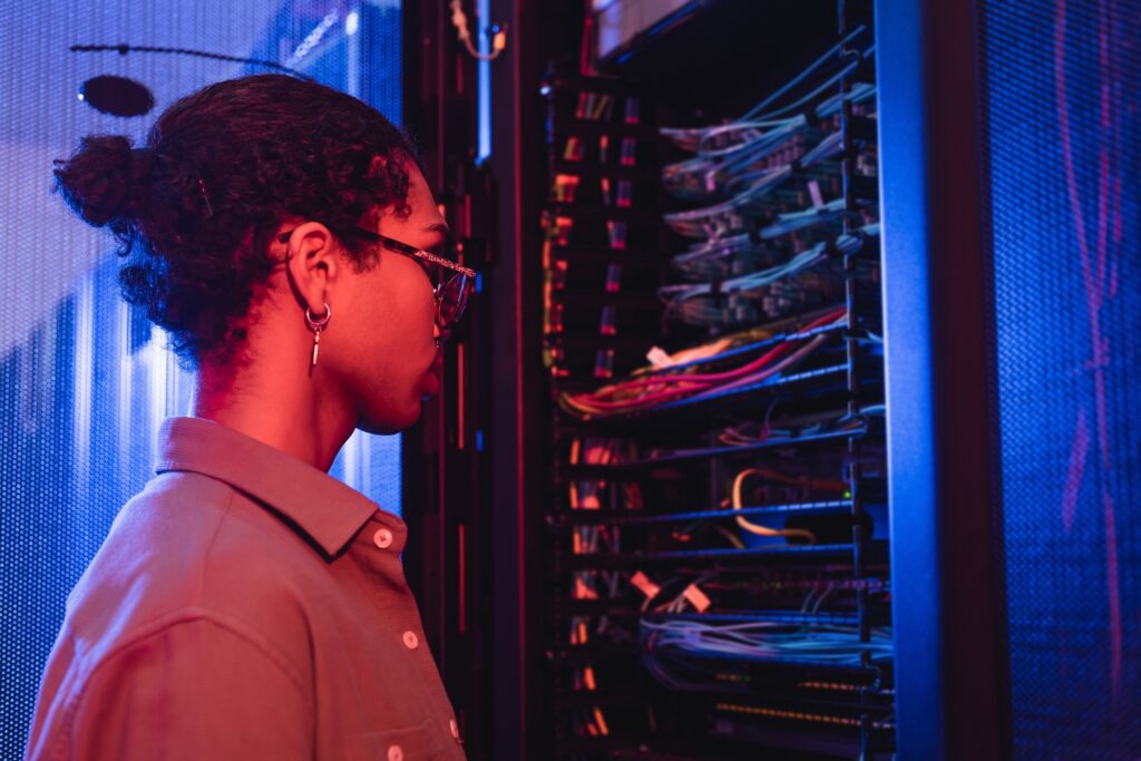 young african american engineer making diagnostics of server in data center